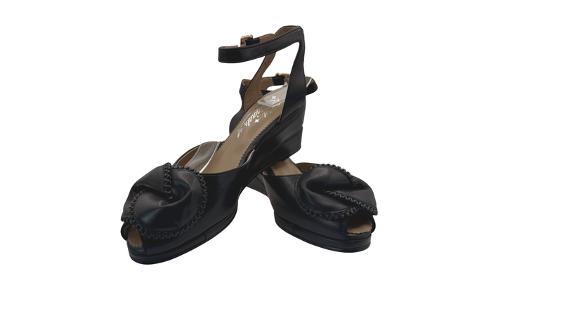 Black open-toe shoes with platform sole on a white background